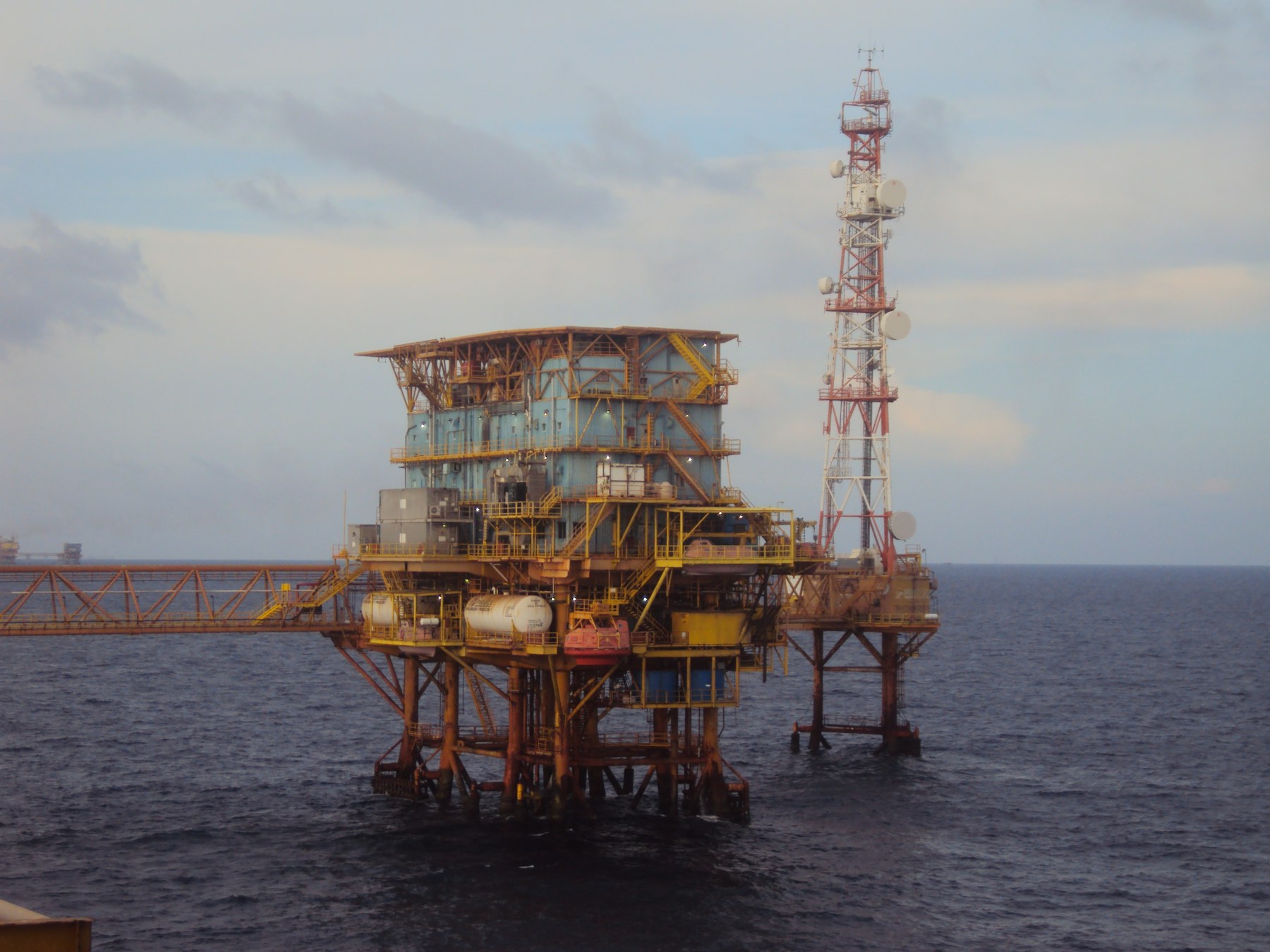 Offshore platform with a communications tower in open water